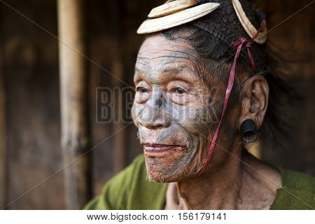 SINGHA CHINGNYU, NAGALAND/INDIA - DECEMBER 8, 2013: Tattooed face of elderly former Singha Chingnyu Village Headhunter. Naga tribes practised headhunting & preserved the heads of enemies as trophies.
