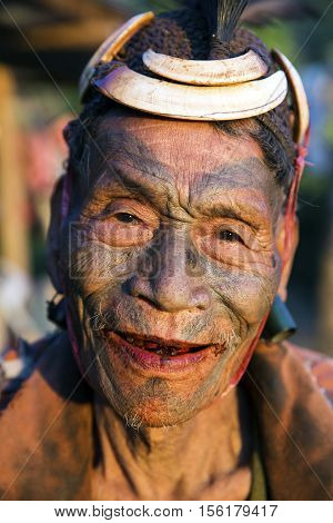 SINGHA CHINGNYU, NAGALAND/INDIA - DECEMBER 8, 2013: Tattooed face of elderly former Singha Chingnyu Village Headhunter. Naga tribes practised headhunting & preserved the heads of enemies as trophies.