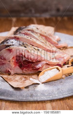some pieces of fresh raw fish with salt and pepper