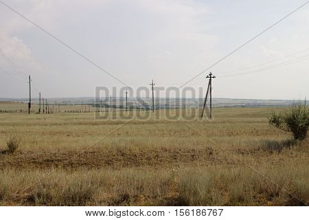 Pillars of the power line in the desert. Volgograd region Russia