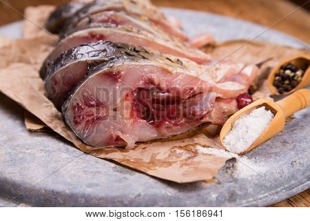 some pieces of fresh raw fish with salt and pepper