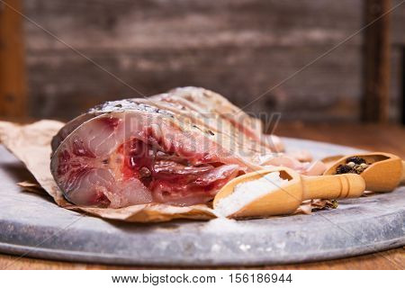 some pieces of fresh raw fish with salt and pepper