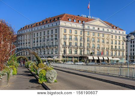 Geneva, Switzerland - 24 September, 2016: view along the Pont des Bergues bridge over the Rhone river, Hotel des Bergues building in the background. The city of Geneva is the capital of the Swiss Canton of Geneva.