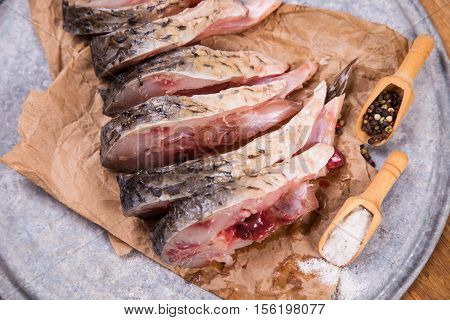 some pieces of fresh raw fish with salt and pepper