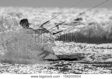 a kitesurfer splashing water, soft focus, shallow DOF