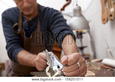 Artisan Lutemaker Working A Violin In His Workshop