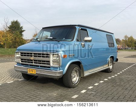 Almere Stad, Flevoland, The Netherlands - November 12, 2016: Blue Chevrolet Chevy Van 20 parked on a public parking spot in the city of Almere. nobody in the vehicle.