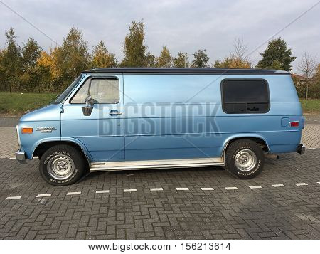 Almere Stad, Flevoland, The Netherlands - November 12, 2016: Blue Blue Chevrolet Chevy Van 20 parked on a public parking spot in the city of Almere. nobody in the vehicle.