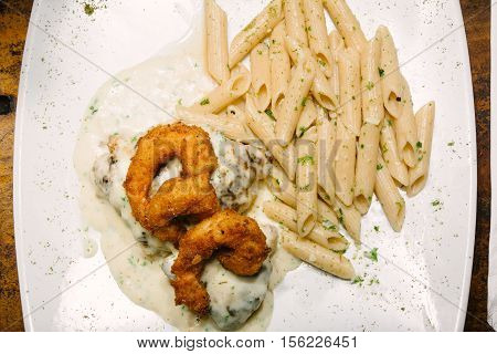 Shrimp breaded with macaroni. Take overhead. White cream.