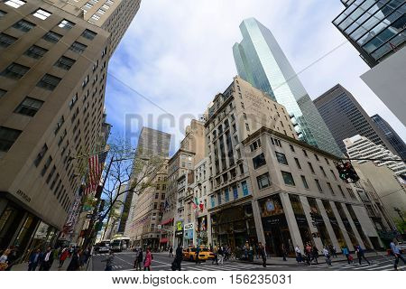 NEW YORK CITY - MAY 6, 2013: Manhattan Intersection and Skyscrapers wide angle at Fifth Avenue on 48th Street, Midtown Manhattan, New York City, USA.