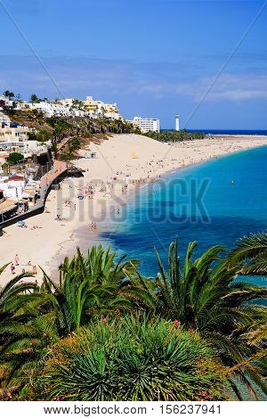 View from above on the beach Playa de Morro Jable with lighthouse on the Canay Island Fuerteventura Spain.