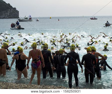 Athletes swim in the icy waters of the sea in the winter during a triathlon