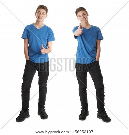 Cute teenager boy in blue T-shirt standing and poinitng forward over white isolated background full body