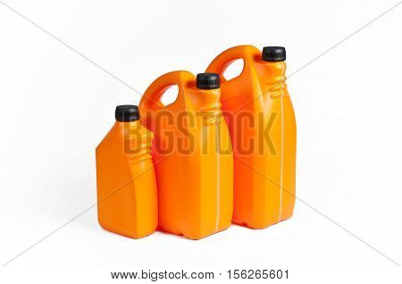 Three orange plastic jerrycans on white background.