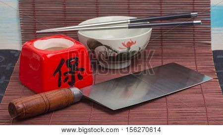 Chinese chef's cleaver knife cai dao on the table with brown mat