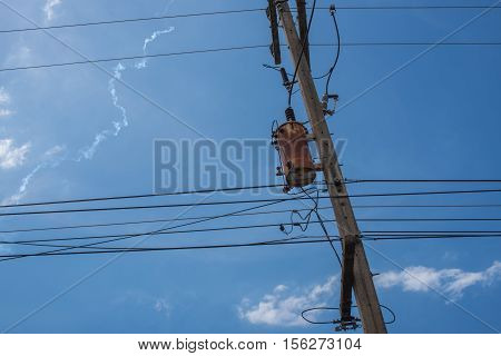 High voltage electrical transformer high on concrete poles