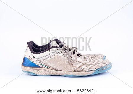 Old blue worn out futsal sports shoes  on white background  isolated