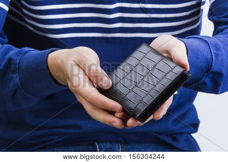 man holding a leather wallet with money