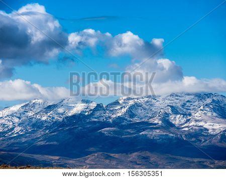 Clouds float over snow capped mountains, Idaho.