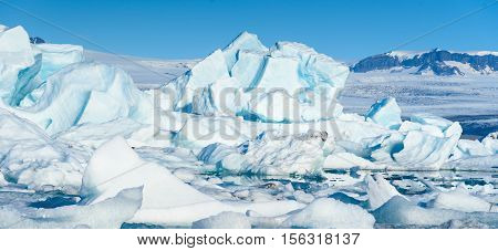 Scenic view of icebergs in Jokulsarlon glacier lagoon Iceland selective focus global warming concept