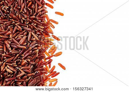 Border of red rice close-up on white background. Isolated. Decorative frame of wild brown unpolished rice.