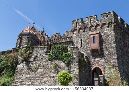 Ancient stone wall with windows stairs and carved turrets against the blue sky. Reichenstein Castle Rhine Valley Germany - UNESCO World Heritage