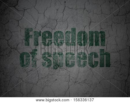Political concept: Green Freedom Of Speech on grunge textured concrete wall background