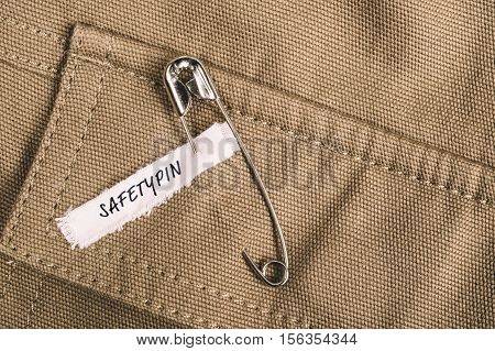Safety pin on clothes with label 