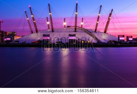 Sunset at the O2 Arena against a purple sky