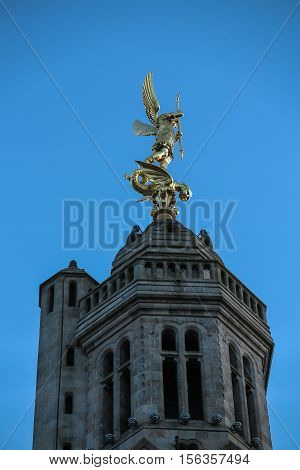 Church of Saint Michael in Saint-Michel-Mont-Mercure France with a large figure of the Archangel Michael at the top of the tower