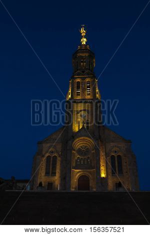 Church of Saint Michael in Saint-Michel-Mont-Mercure France with a large figure of the Archangel Michael at the top of the tower