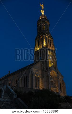 Church of Saint Michael in Saint-Michel-Mont-Mercure France with a large figure of the Archangel Michael at the top of the tower