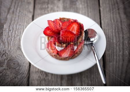 Strawberry and custard tart on a white plate