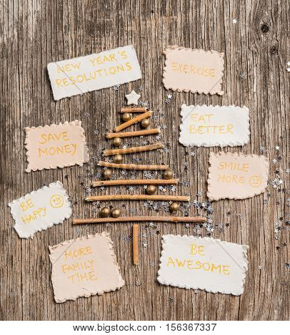 Christmas Tree And New Year Resolutions On Rustic Wooden Background