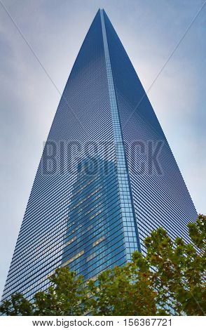 SHANGHAI, CHINA - NOV 5, 2015: Beautiful Shanghai World Financial Center building and tree, Shanghai - financial and commercial center of China