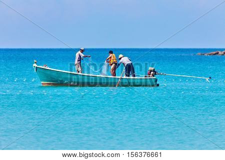 KOOD ISLAND, THAILAND-25 NOVEMBER, 2011: Local fisherman in the boat pulled out a fishing net near the  Kood island in Thailand