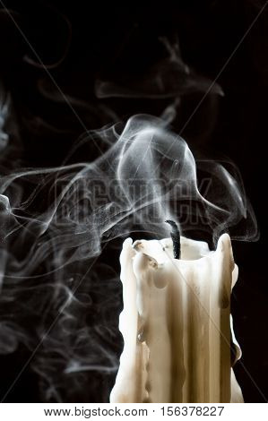 Close up candle with smoke on black background