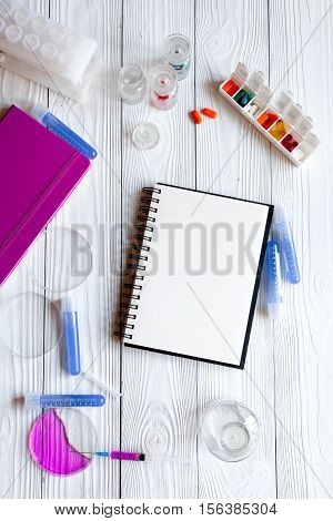 medical student working place with blank open notebook at wooden table top view