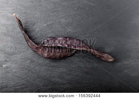 The pod of the carobon a stone plate