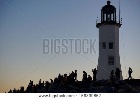 people taking photos of the moon at Scituate lighthouse