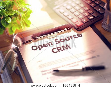 Clipboard with Concept - Open Source CRM with Office Supplies Around. 3d Rendering. Blurred Toned Illustration.