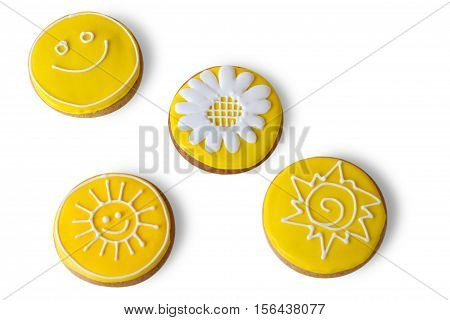 Top view of iced biscuits. Yellow cookies with decoration. Smiley face and sun. Art starts with simplest things.