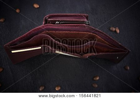 Brown women's purse on a wooden background