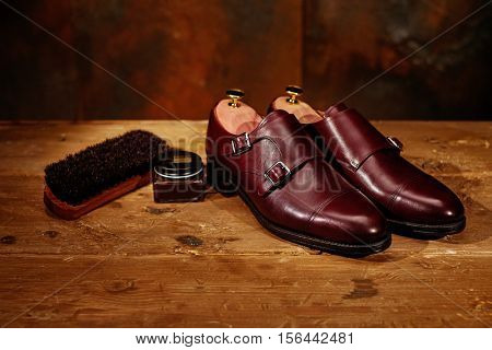 Still life with men's leather shoes and accessories for shoes care