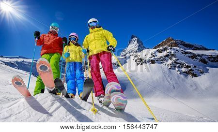 Skiing, winter, snow, sun and fun - family enjoying winter vacations in Zermatt, Switzerland.