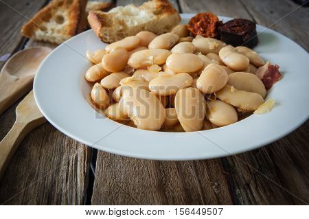 fabada is a typhical spanish legumes dish with big beans and sausage