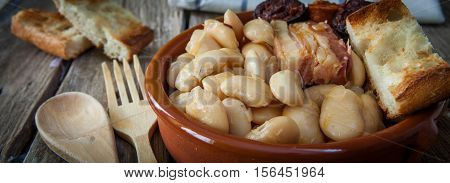 fabada is a typhical spanish legumes dish with big beans and sausage