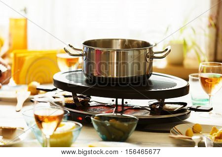 Traditional Swiss winter meal on the tabble. Raclette.