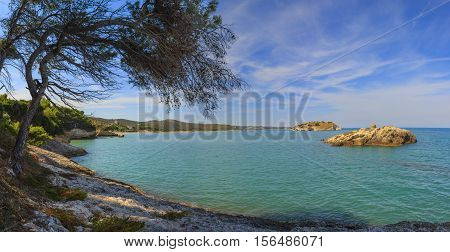 The most beautiful coasts of Italy: bay of Vieste.-(Apulia, Gargano) -In the foreground the Gattarella islet and in the background the town of Vieste.