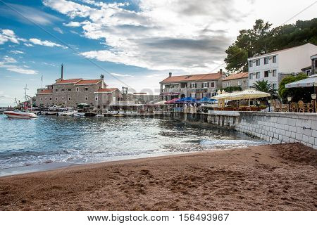 PETROVAC, MONTENEGRO - SEPTEMBER 20, 2016:The old town of Petrovac with the ruins of a medieval fortress and the bay for tourist and fishing vessels,Montenegro.